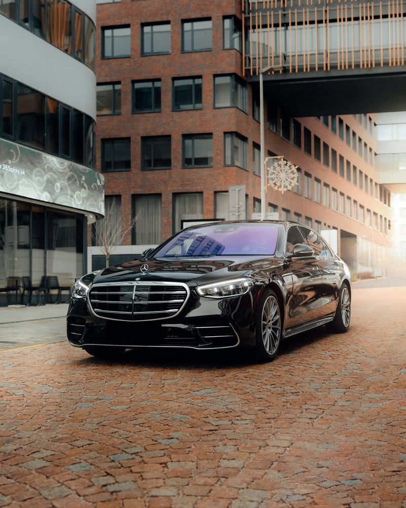 Black Mercedes-Benz S-Class on a brick street